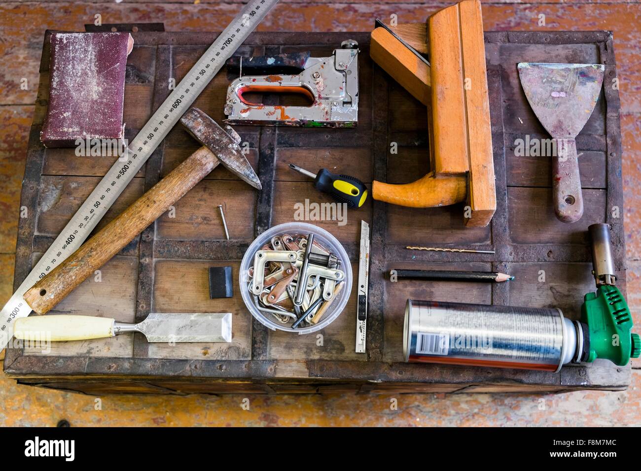 Overhead view of hand tools on wooden trunk suitcase Stock Photo