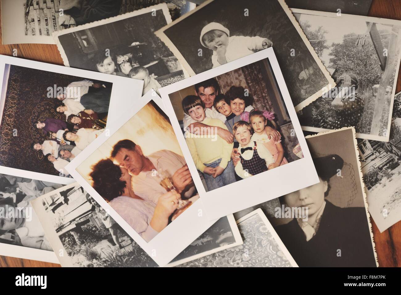 Pile of family photographs on table, overhead view Stock Photo