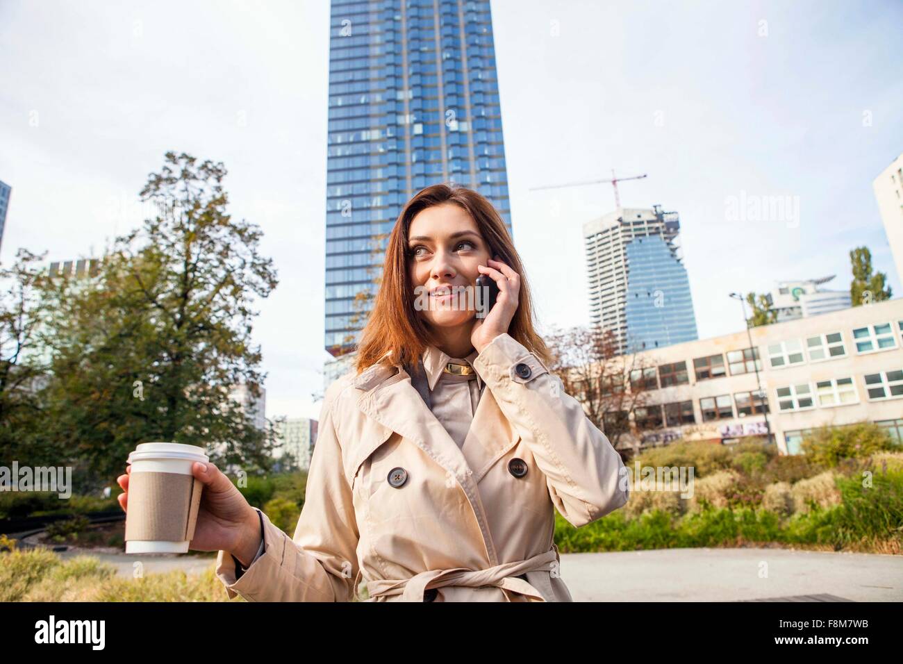 Businesswoman on smartphone, Warsaw, Poland Stock Photo
