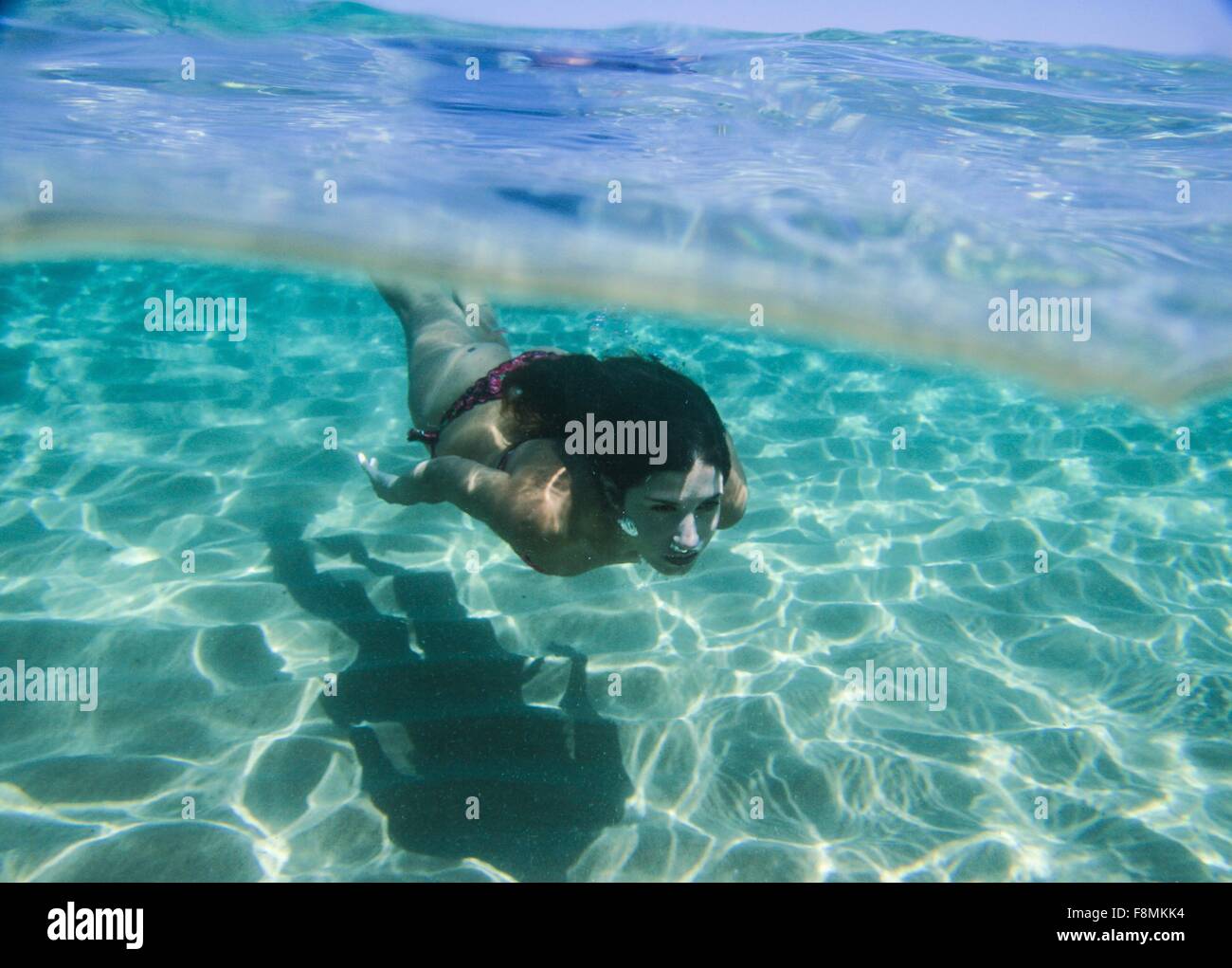 Young woman swimming underwater in ocean Stock Photo - Alamy