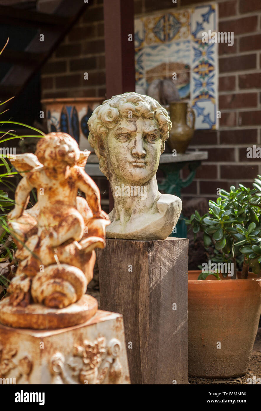 Garden statues in home of designer Erica Pols. A classical style bust