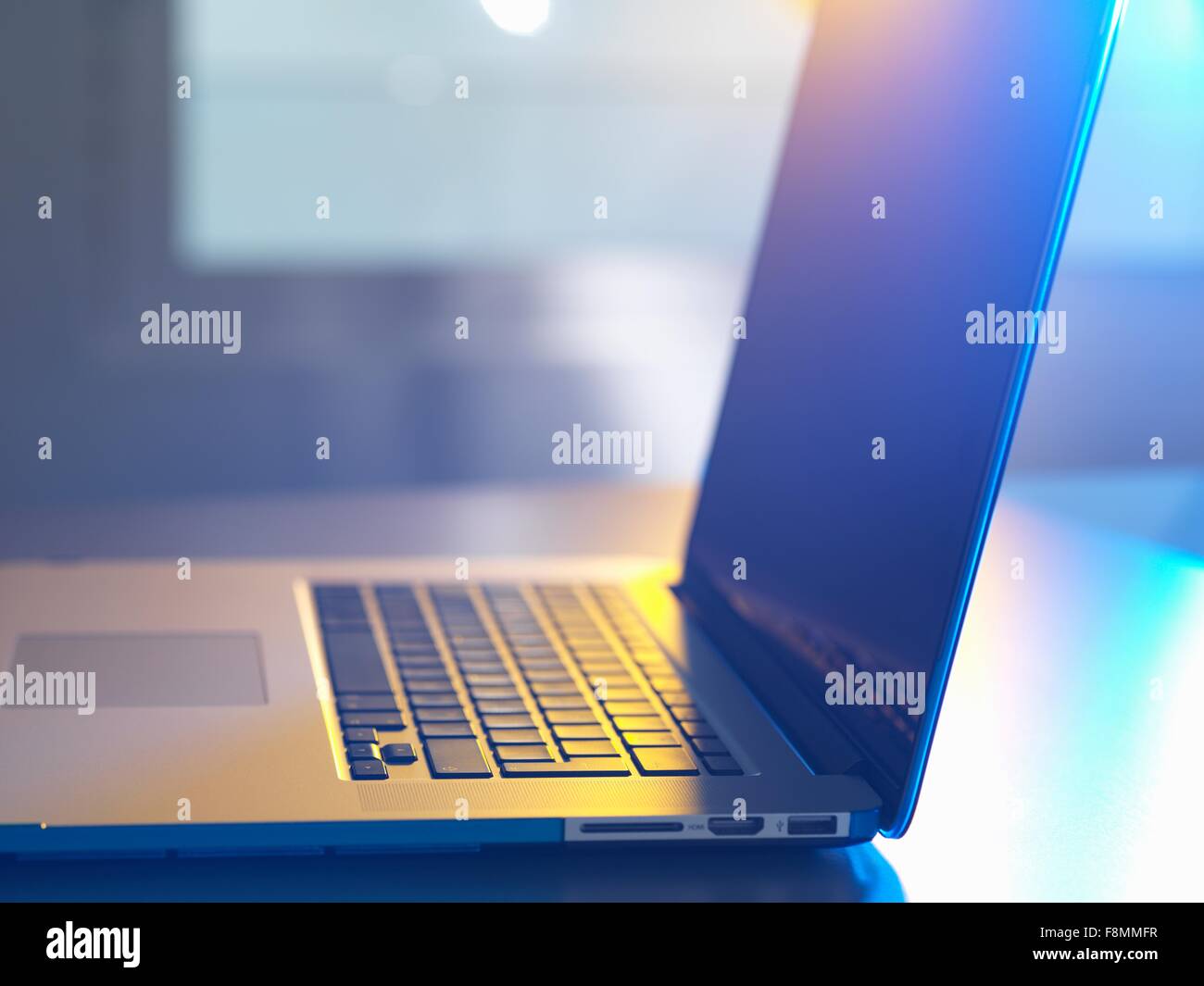 Side view of open laptop on desk Stock Photo