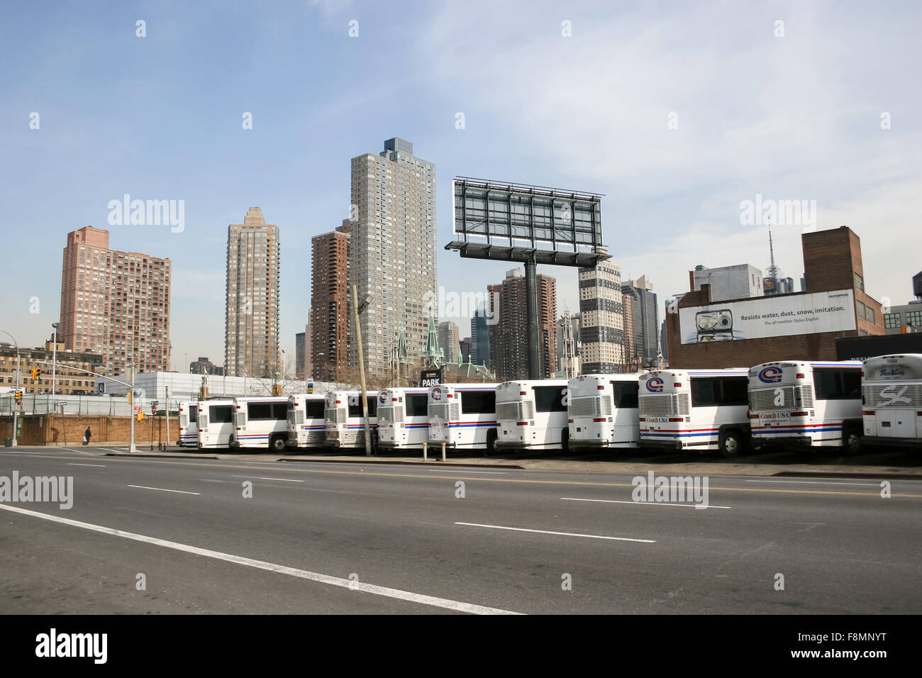 A large group of buses parked in the city bus garage on West 38 street