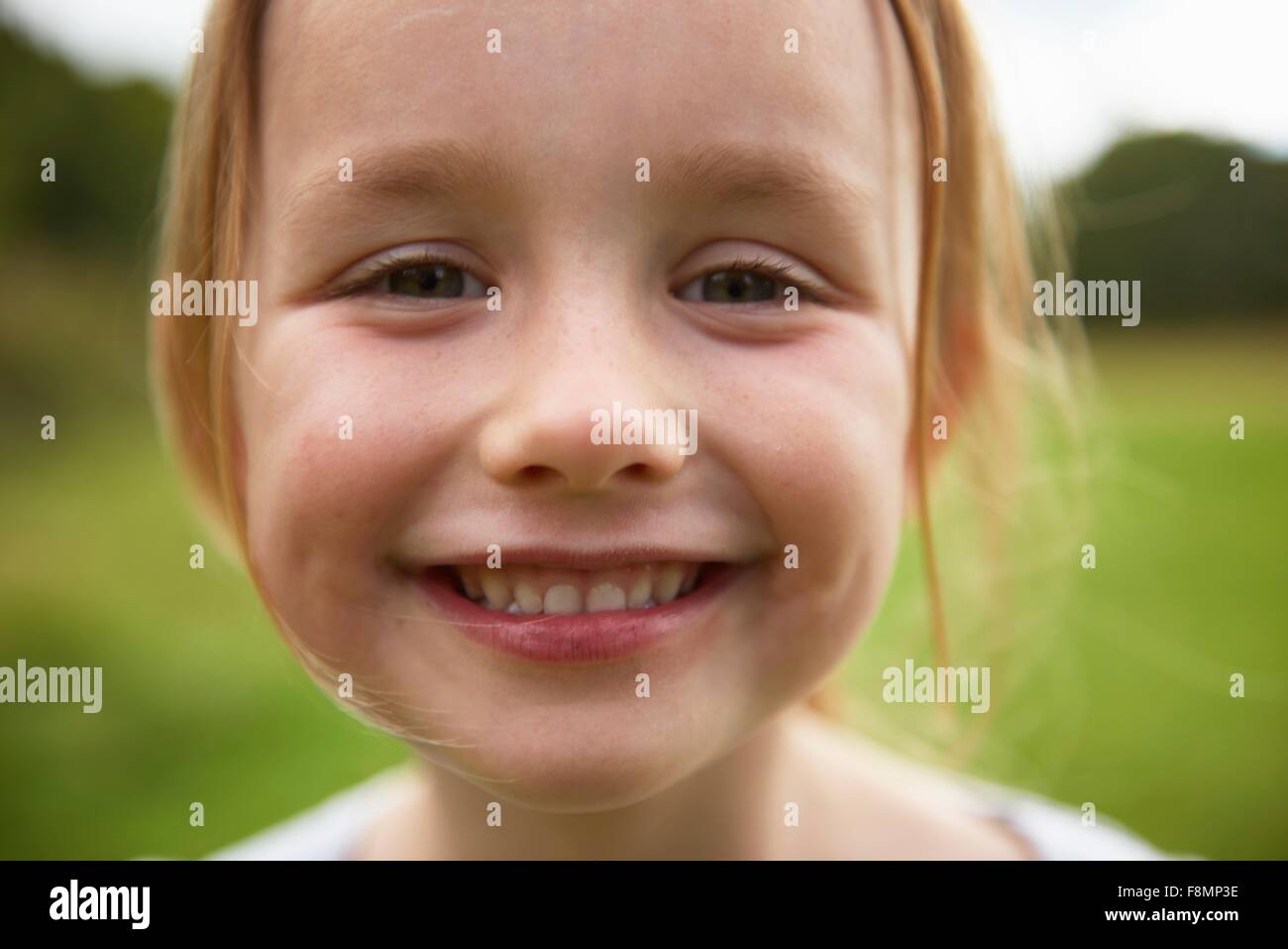 Portrait of young girl in field, smiling, close-up Stock Photo - Alamy