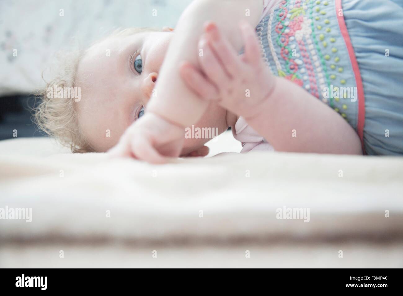 Baby girl lying down Stock Photo