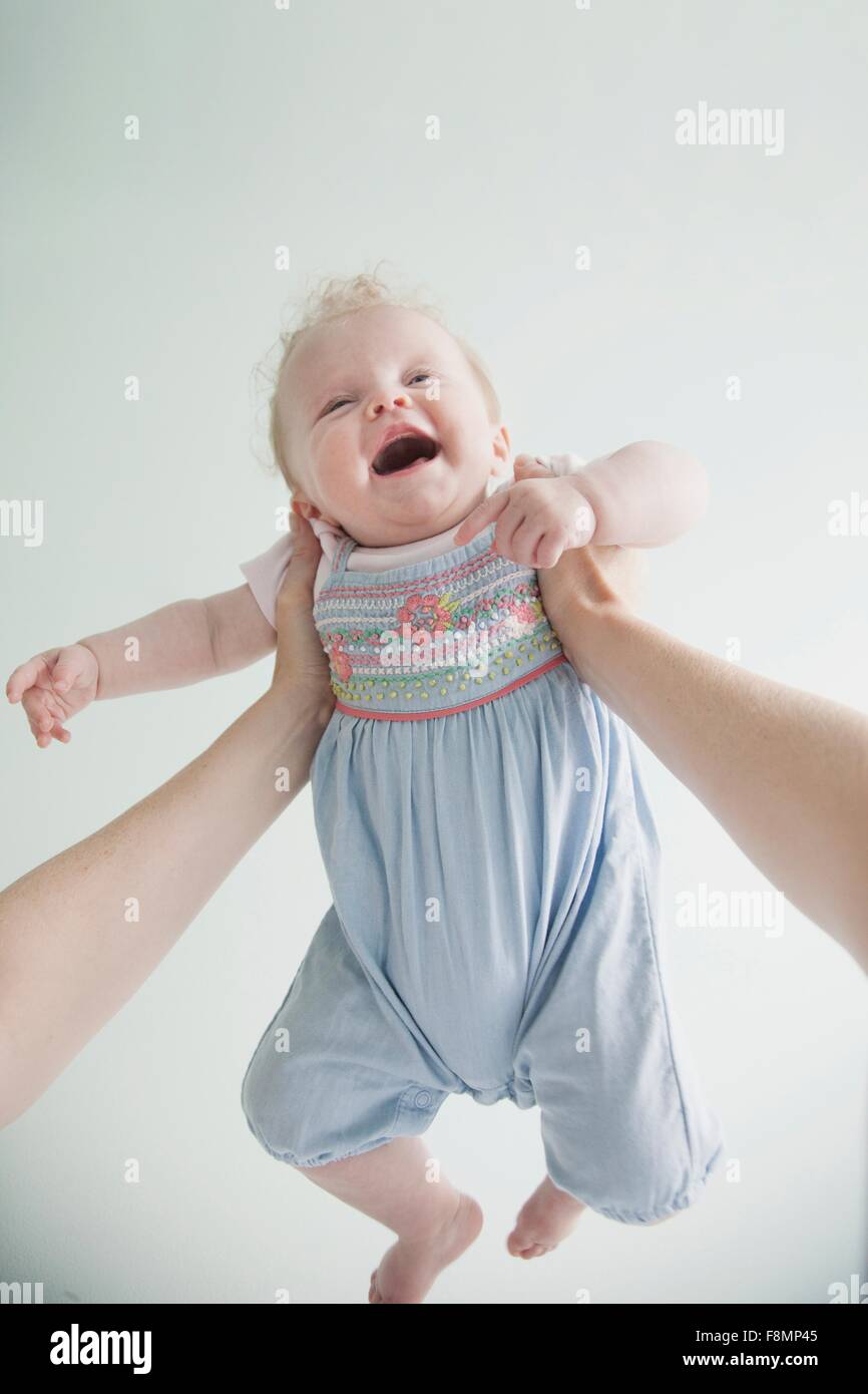 Mother holding baby daughter in air Stock Photo