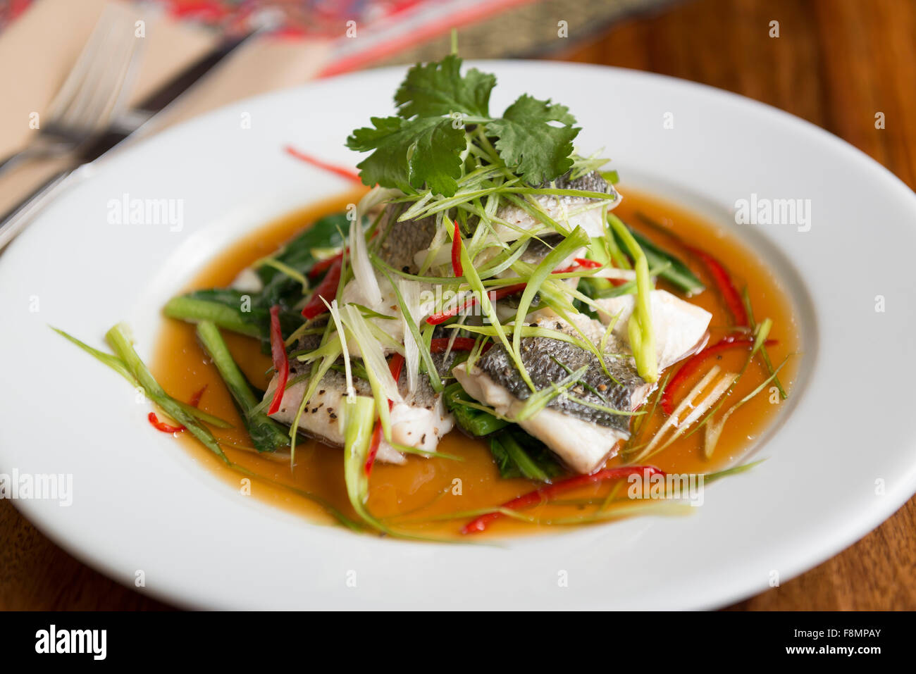 Singapore cuisine served in a restaurant. Fish. Stock Photo