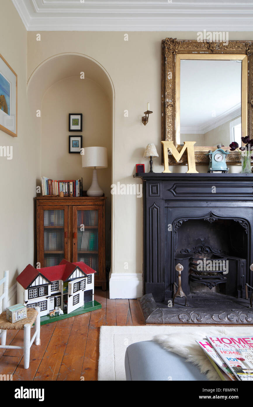 Black Fireplace With Art Nouveau Details Gold Famed Mirror And A