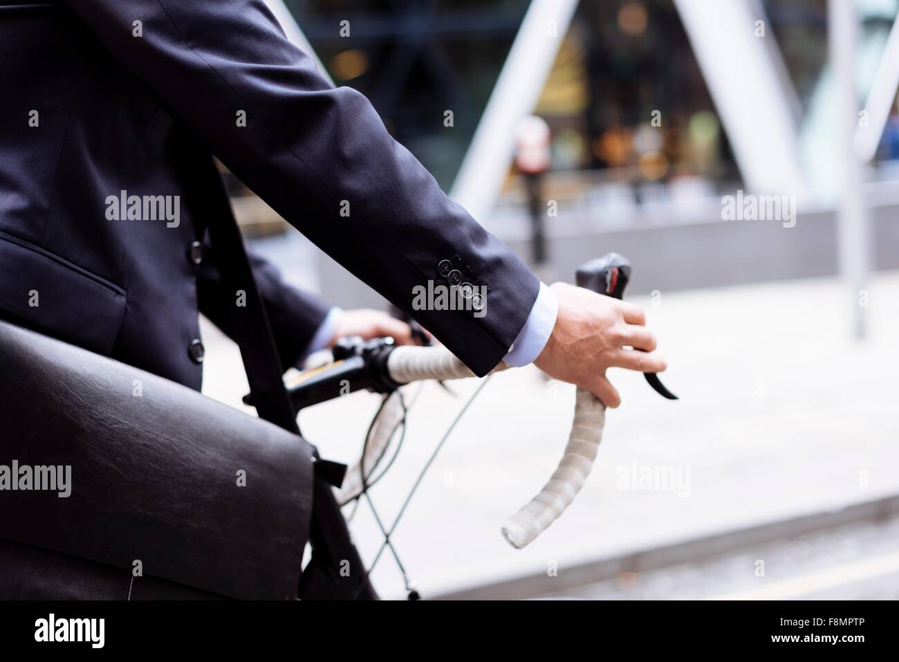 Businessman walking with bike Stock Photo