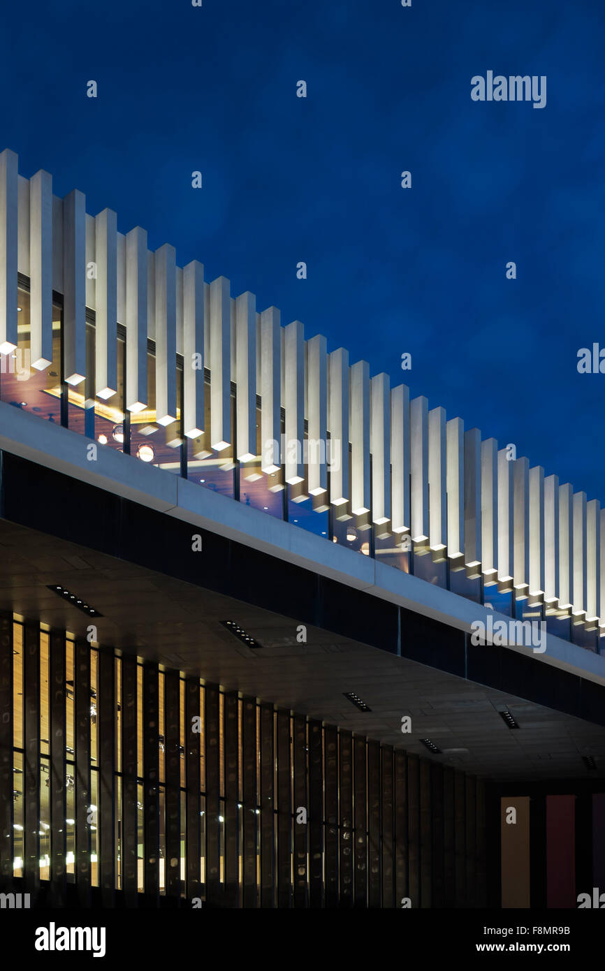 The Opera House in Linz, Austria. Exterior view of the Opera House illuminated at night. Glass facade. Stock Photo