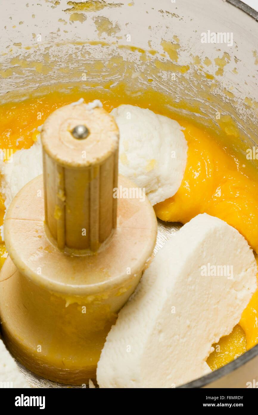 Ricotta and fruit puree in a food processor Stock Photo