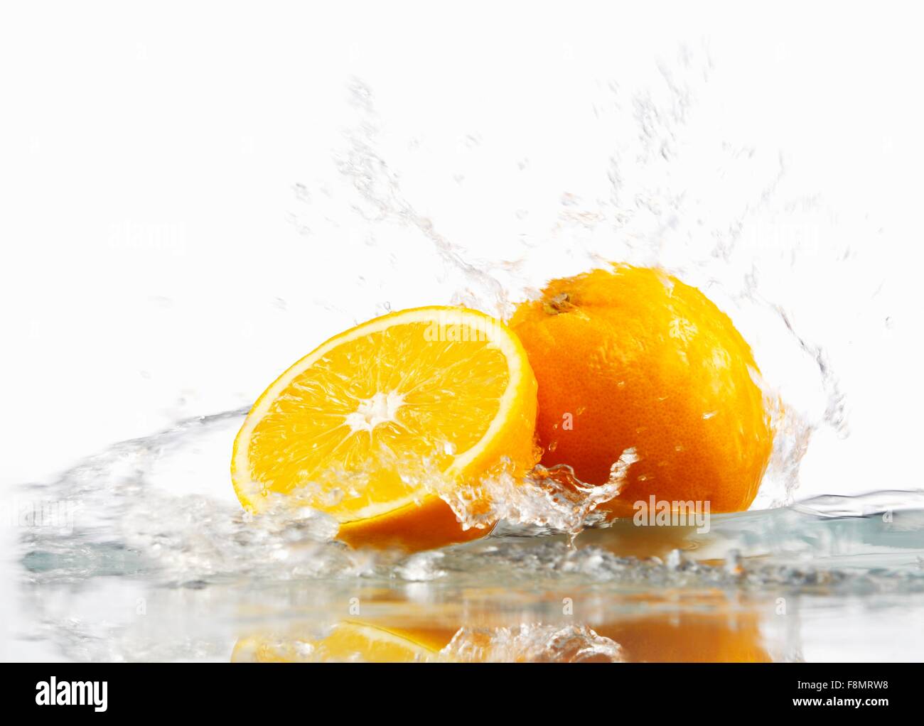 Oranges with splashing water Stock Photo Alamy