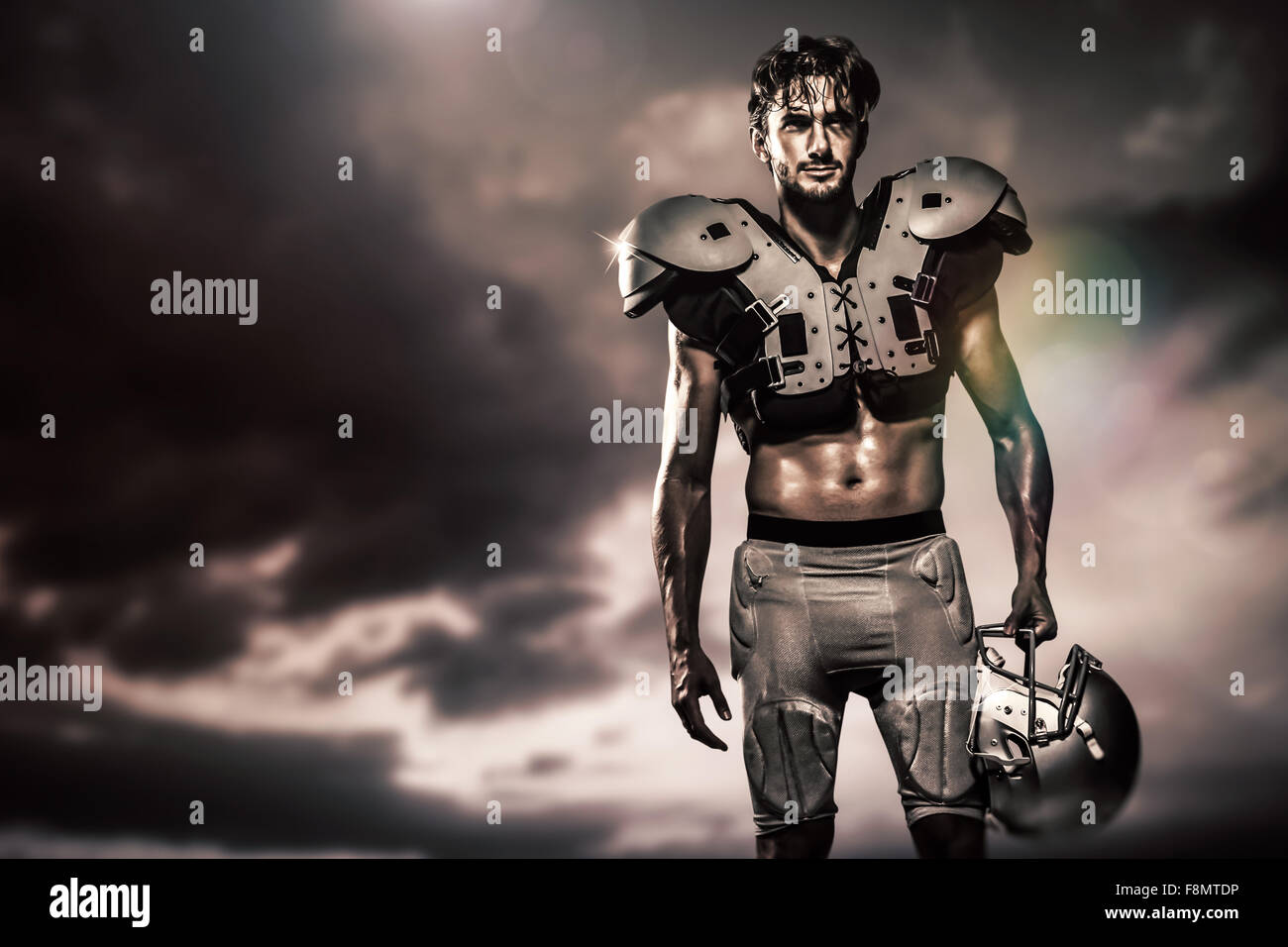 Composite image of shirtless american football player with padding