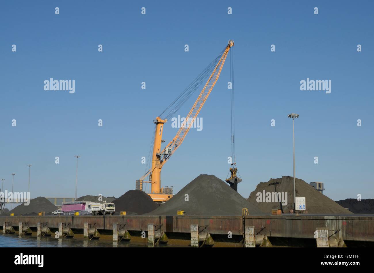 A crane loading coal at the Port of Huelva, Spain Stock Photo - Alamy
