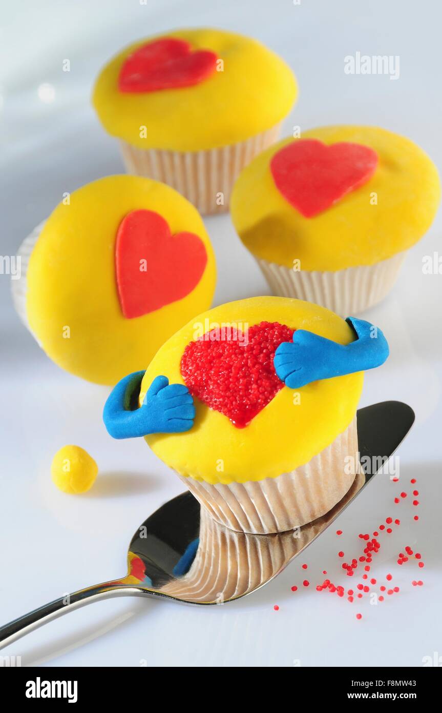 Yellow cupcakes decorated with hearts Stock Photo