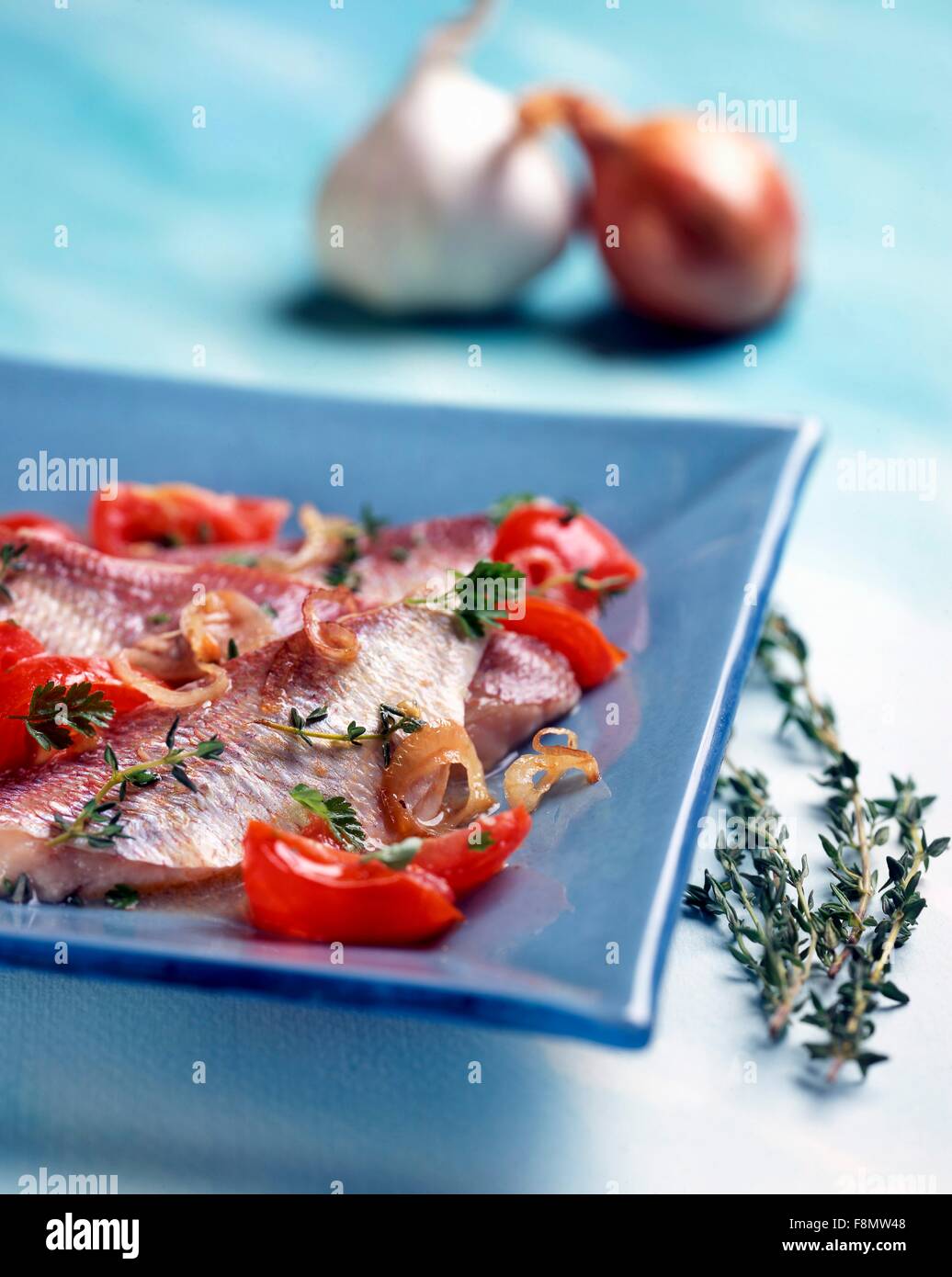Triglie alla livornese (red mullet with tomatoes, onions and thyme) Stock Photo