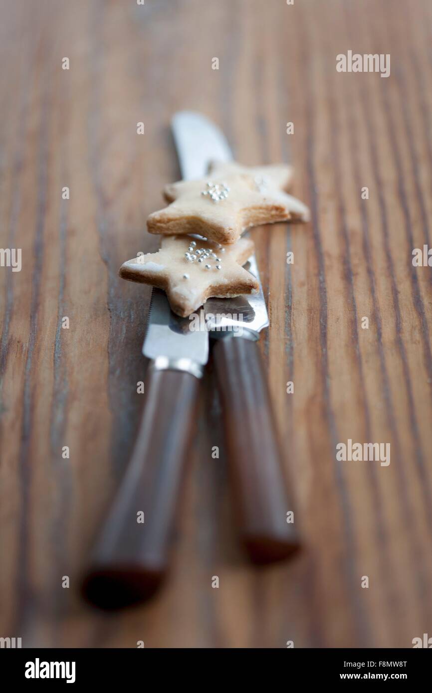 Starshaped biscuits on two knives Stock Photo Alamy