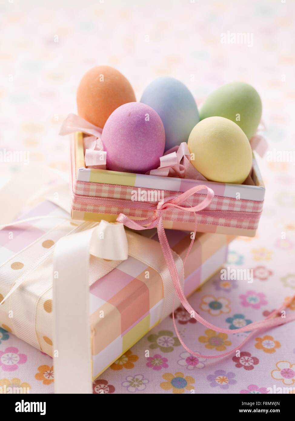 An Easter parcel and brightly coloured eggs for Easter Stock Photo Alamy
