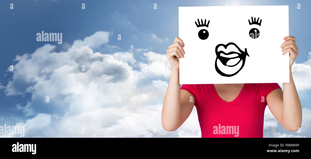 Composite image of woman in pink t-shirt showing card Stock Photo