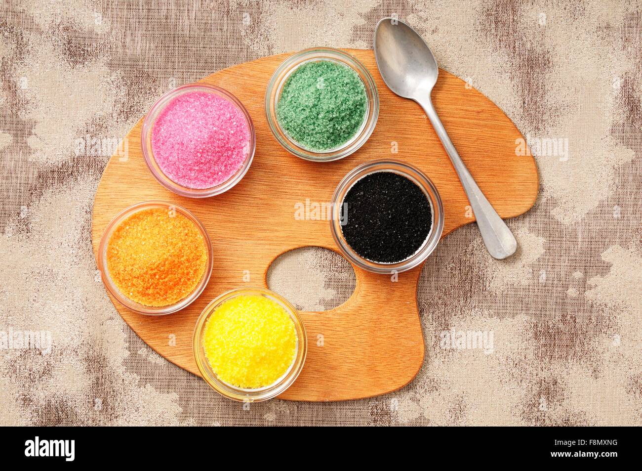 Coloured sugar in small pots on a palette Stock Photo Alamy