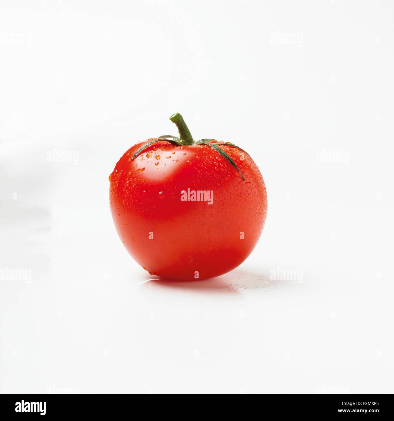 A tomato with drops of water Stock Photo