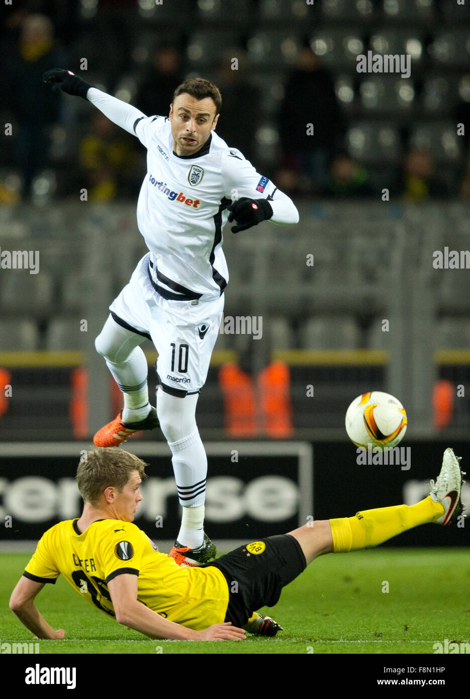 Dortmund, Germany. 10th Dec, 2015. Dortmund's Matthias Ginter (bottom) and PAOK's Dimitar Berbatov compete for the ball during the Europa League Group C football match between Borussia Dortmund and PAOK FC at the Signal Iduna Park in Dortmund, Germany, 10 December 2015. PHOTO: BERND THISSEN/DPA/Alamy Live News Stock Photo