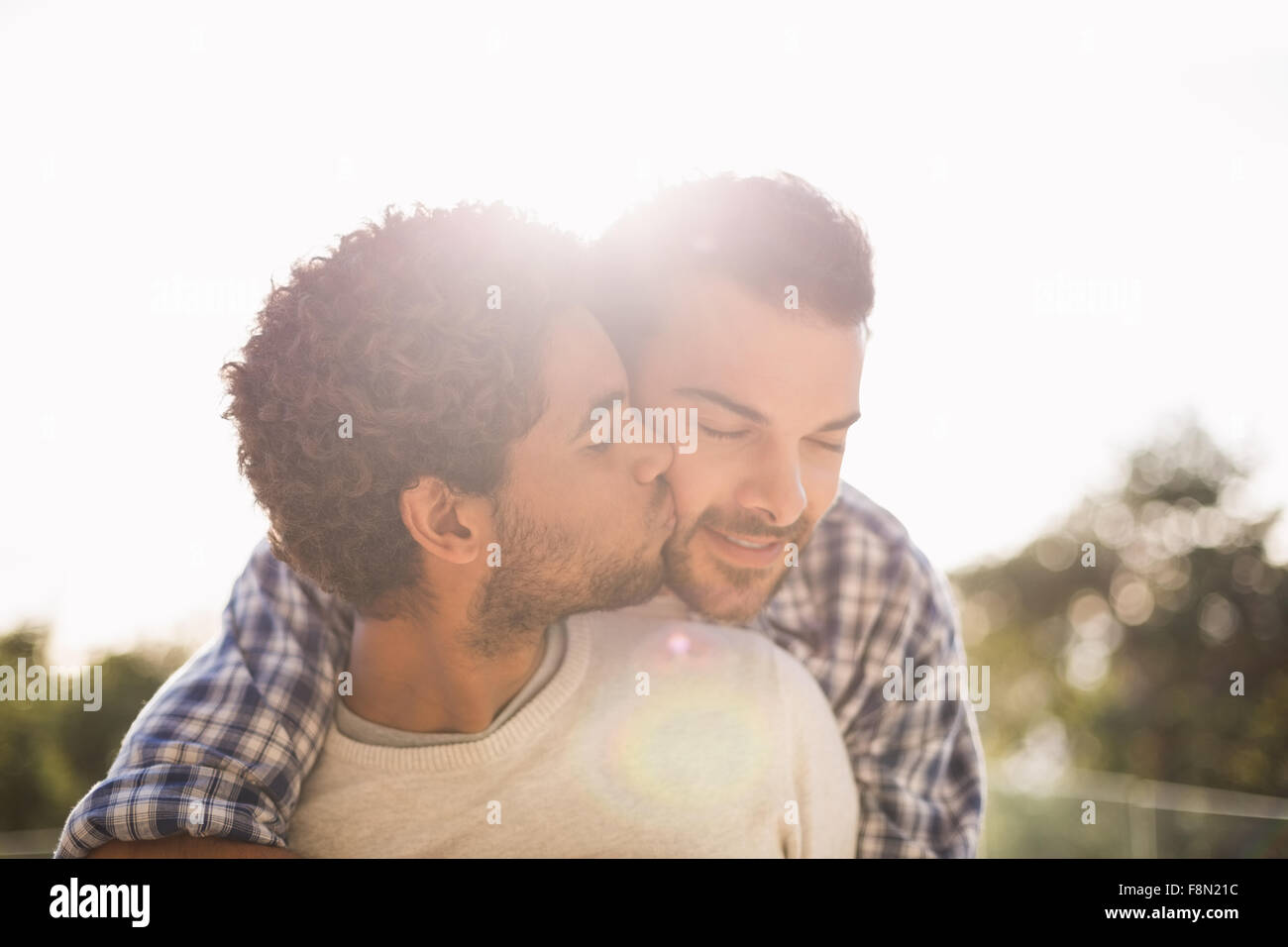 Happy gay couple cuddling Stock Photo