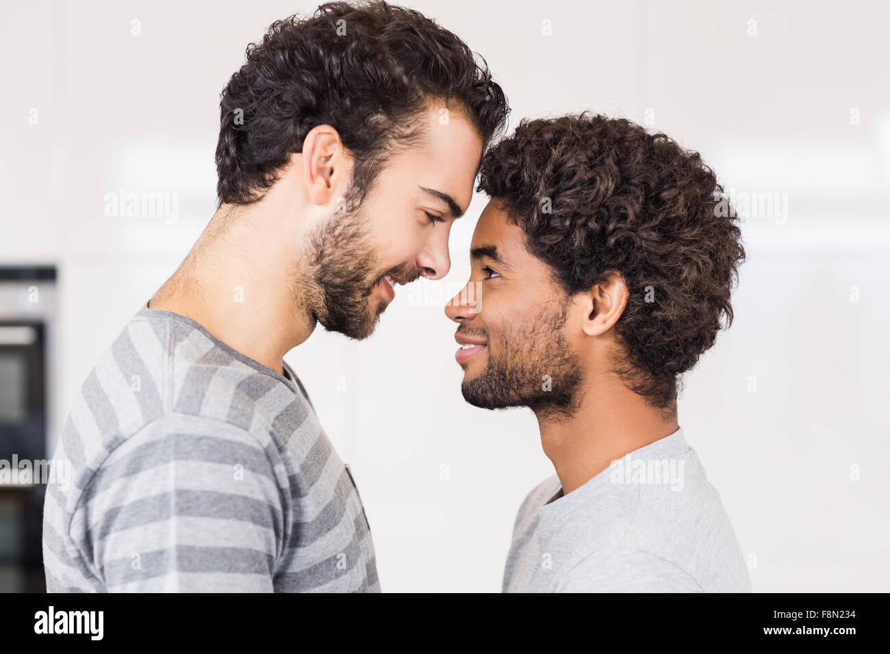 Smiling gay couple looking to each other Stock Photo