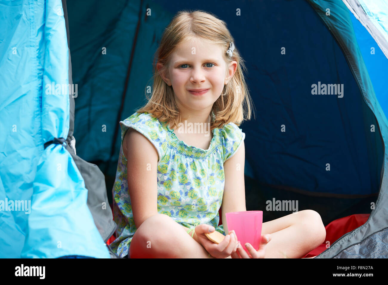 Girl Having Snack On Camping Trip Stock Photo