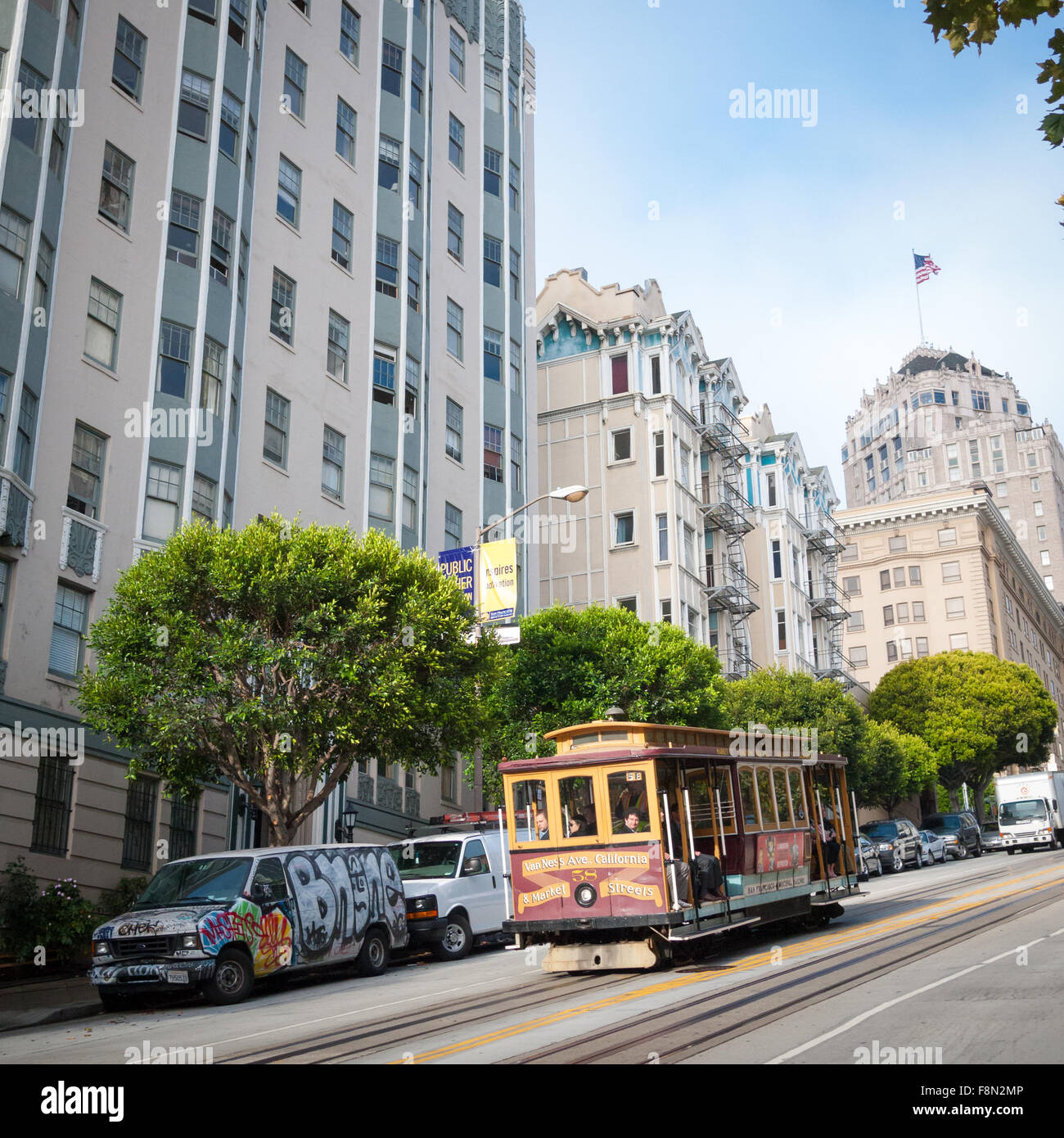 A view of the California Street cable car moving down steep Nob Hill on California Street in San Francisco, California. Stock Photo