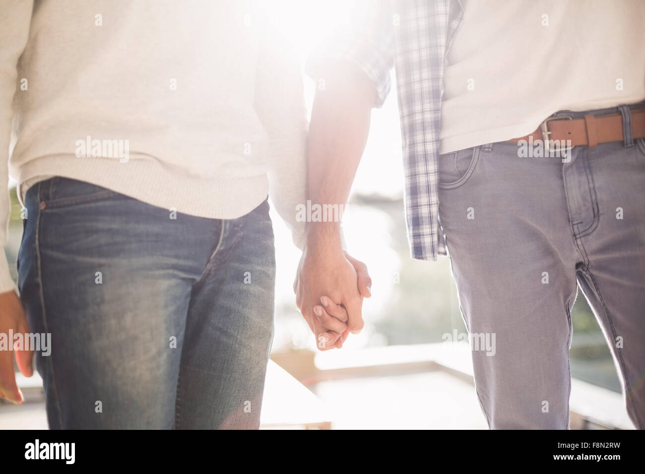 Close up of gay couple holding hands together Stock Photo
