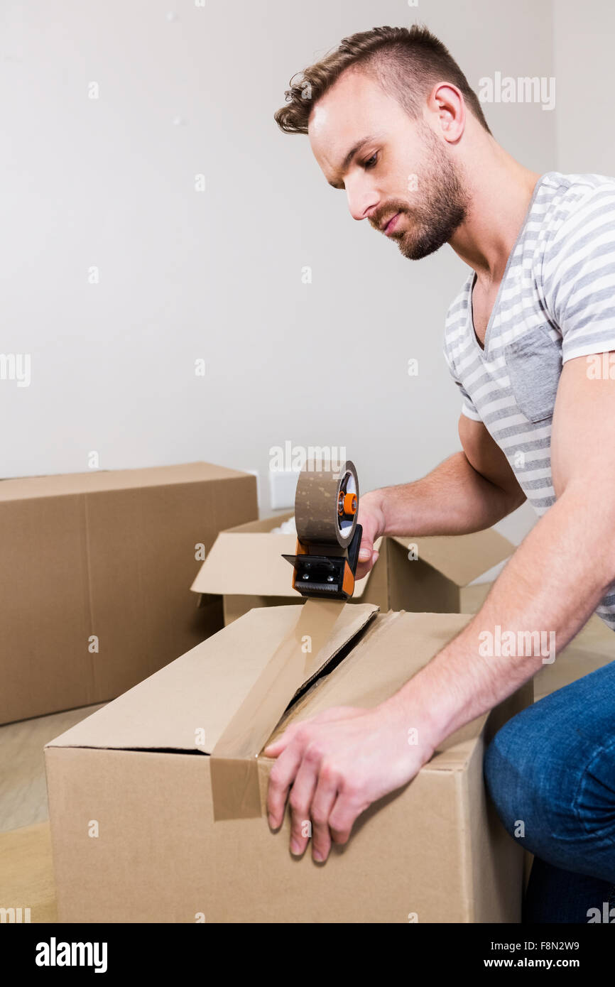 Man taping up moving box Stock Photo