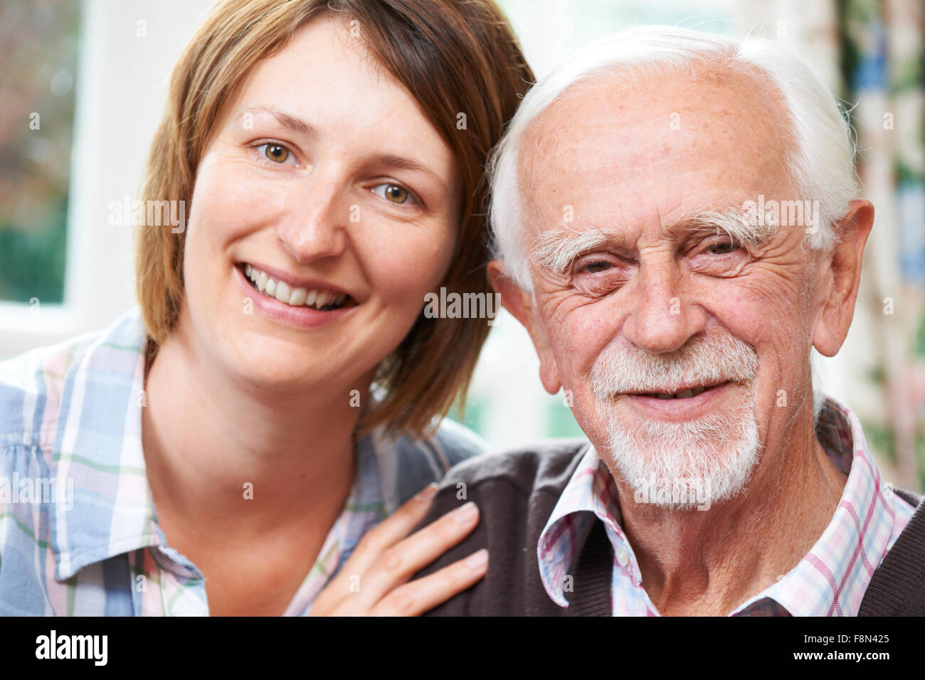 Senior Man With Adult Daughter At Home Stock Photo
