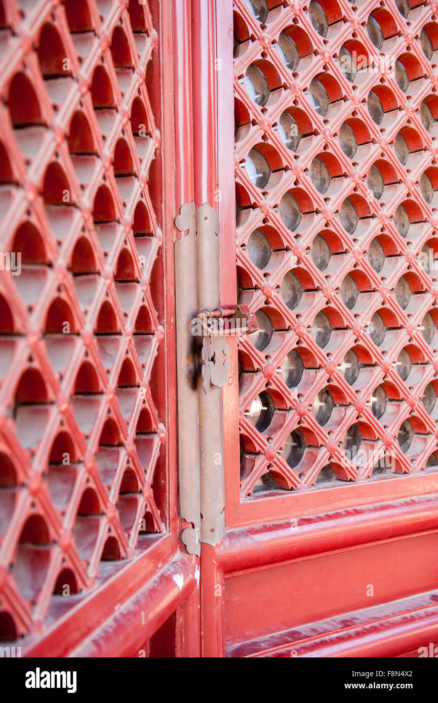 Red shutter doors with gold handles in Asia Stock Photo