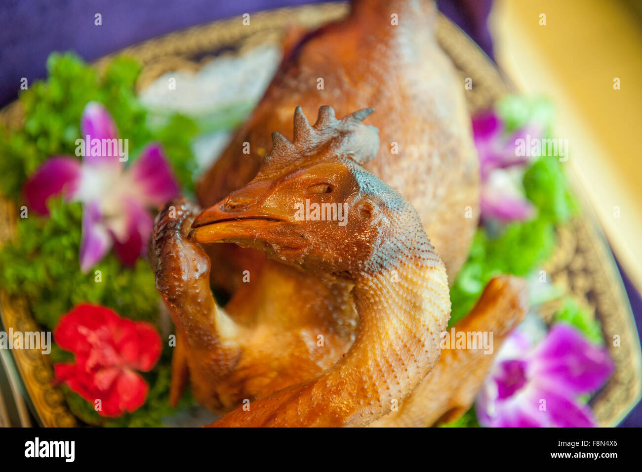 Whole chicken on a dish to be served at restaurant Stock Photo