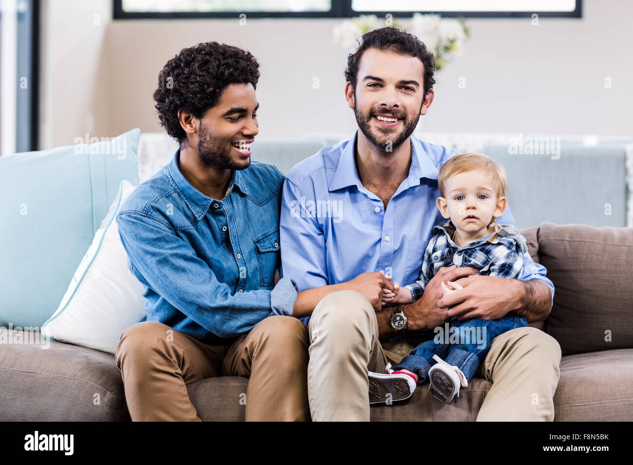 Happy gay couple with child Stock Photo