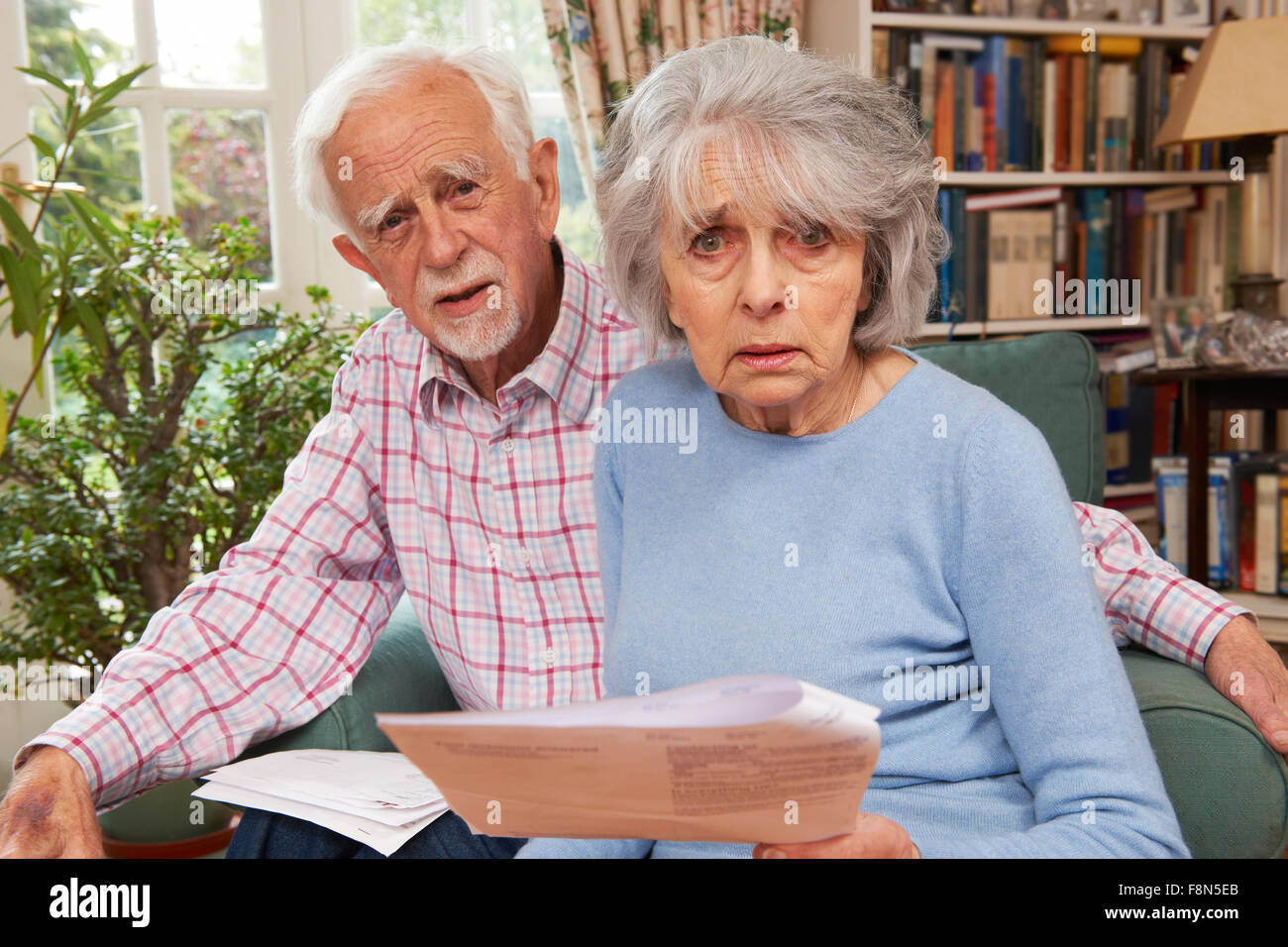 Senior Couple Going Through Finances Looking Worried Stock Photo