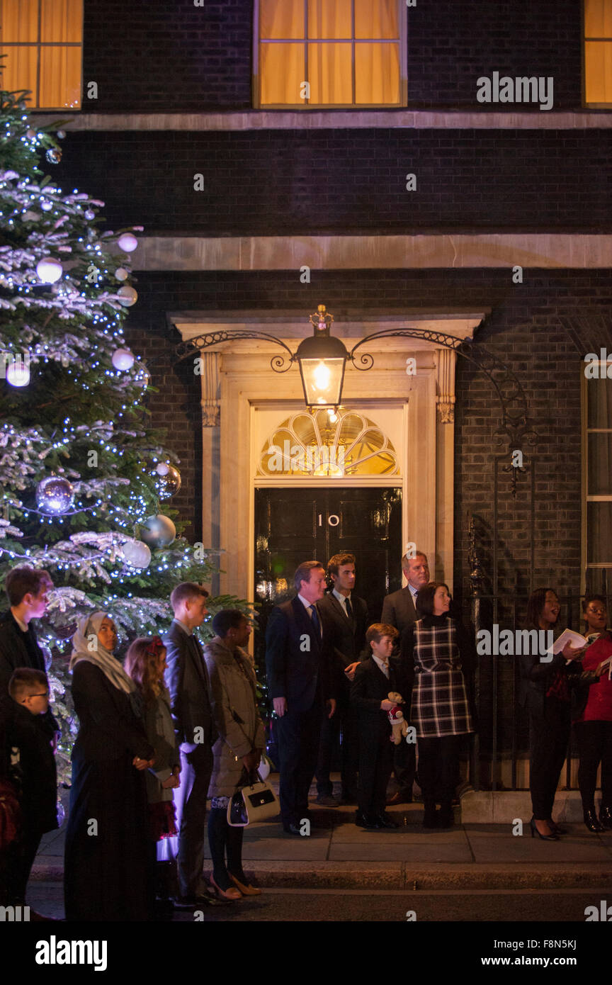 10 Downing Street, London, UK. 10th December, 2015. The Downing Street christmas tree is lit, watched by PM David Cameron and guests including charity fundraiser Ted McCaffrey, 8, who lit the tree. Credit:  Malcolm Park editorial/Alamy Live News Stock Photo