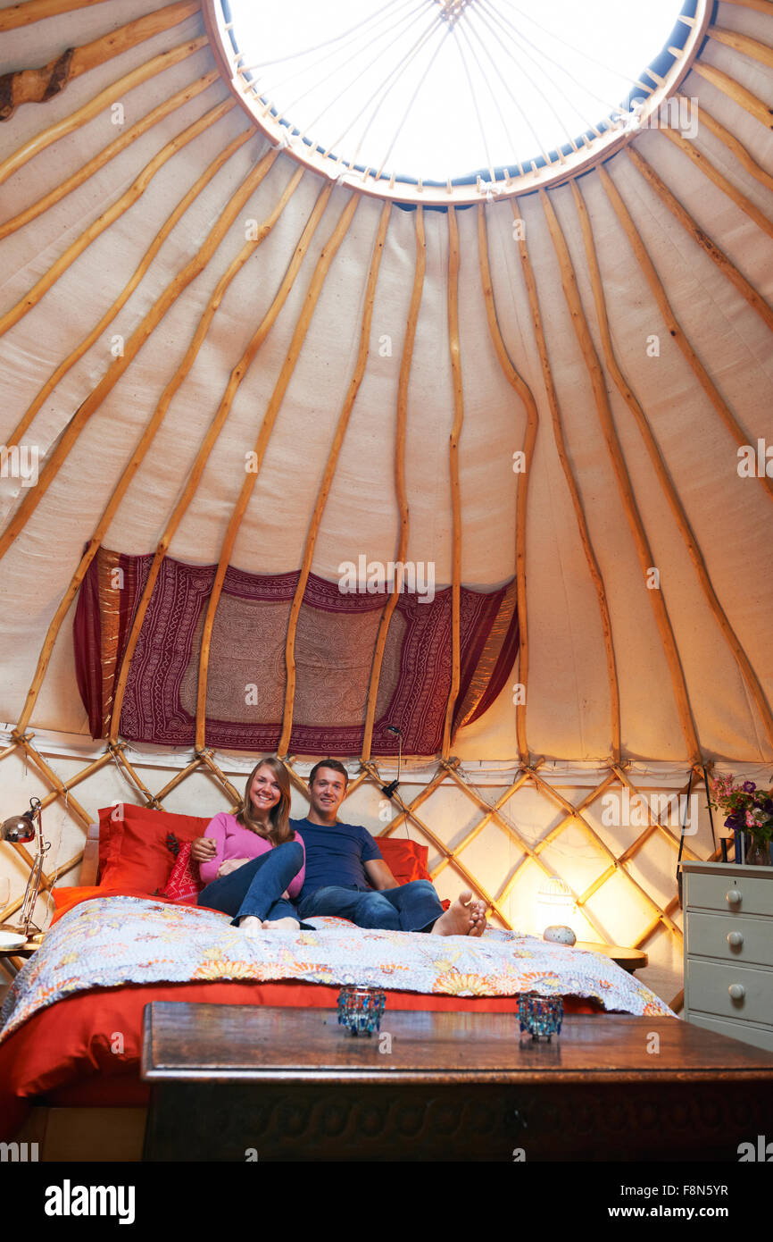 Couple Enjoying Luxury Camping Holiday In Yurt Stock Photo
