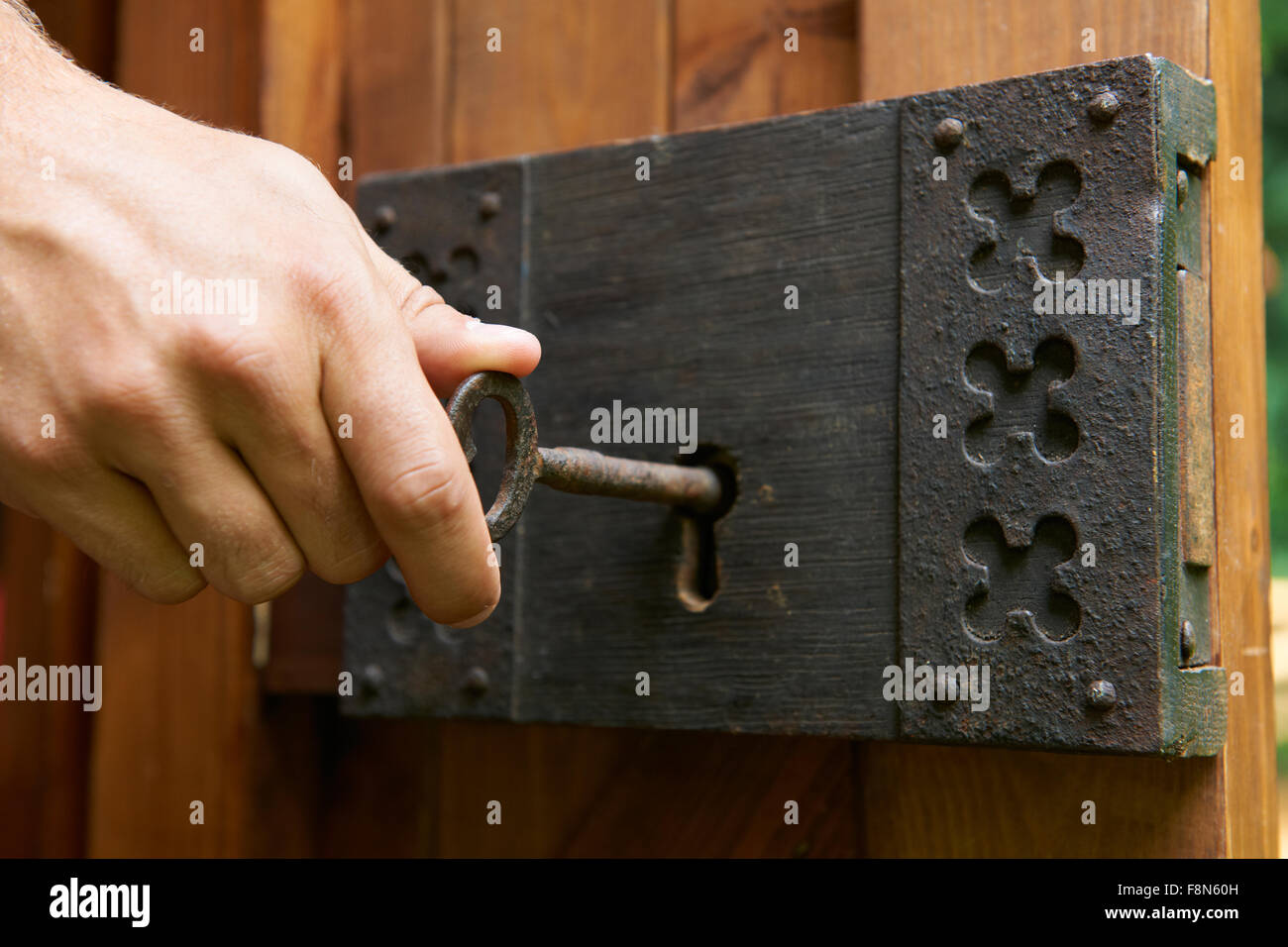 Hand Turning Key In Old Fashioned Lock Stock Photo Alamy