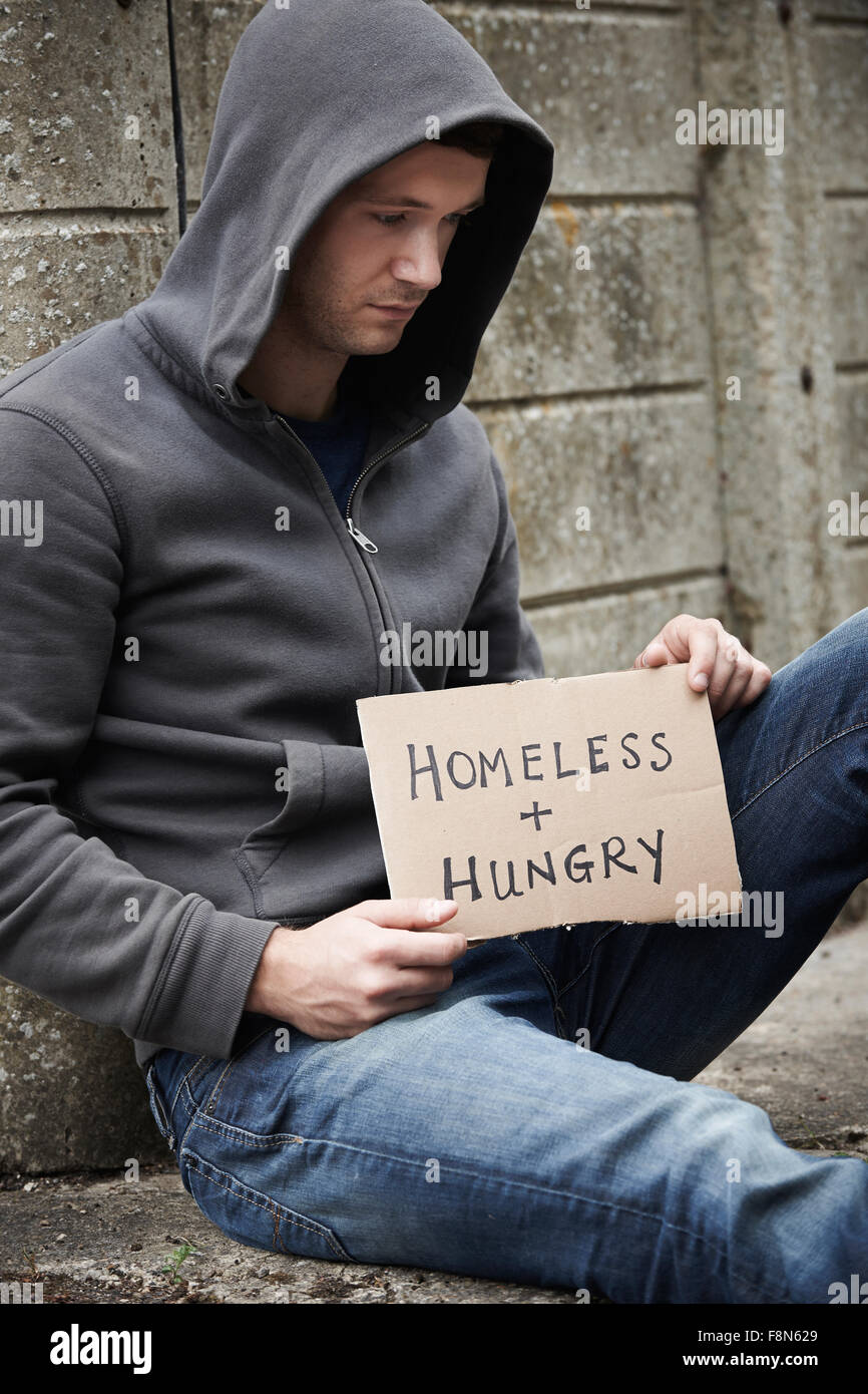Homeless Young Man Begging On Street Stock Photo
