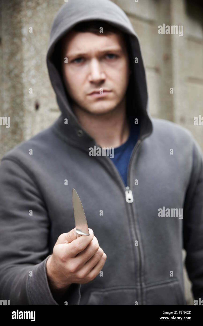 Threatening Looking Man Holding Knife Stock Photo