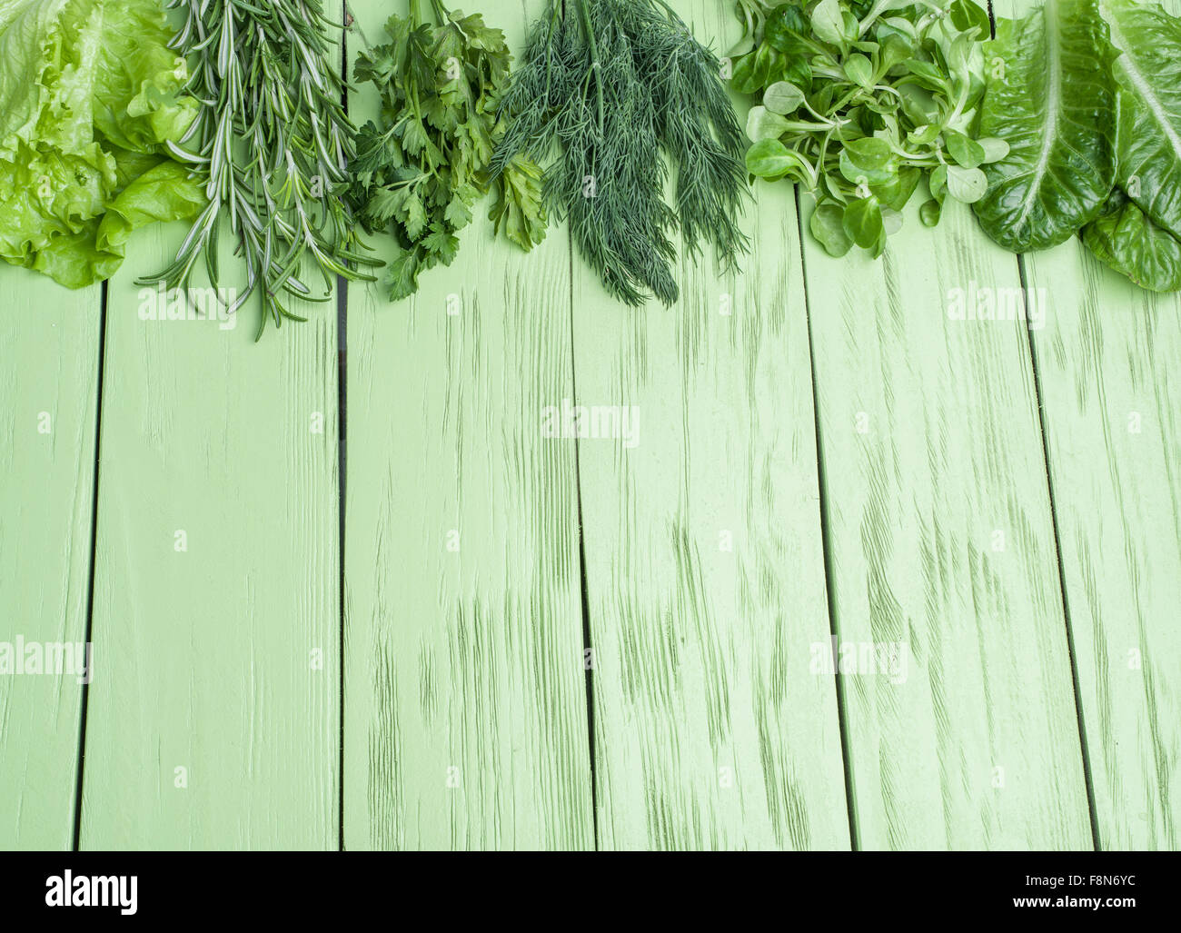 Green herbs on the green wooden background. Stock Photo