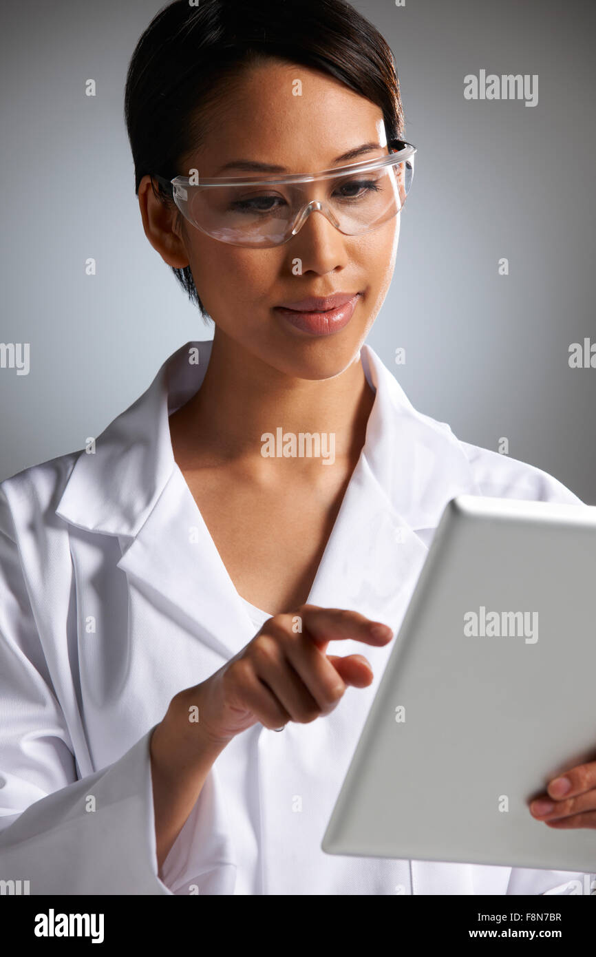 Studio Portrait Of Female Laboratory Worker With Digital Tablet Stock Photo