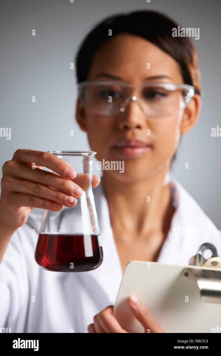 Scientist With Clipboard Examining Beaker Stock Photo Alamy