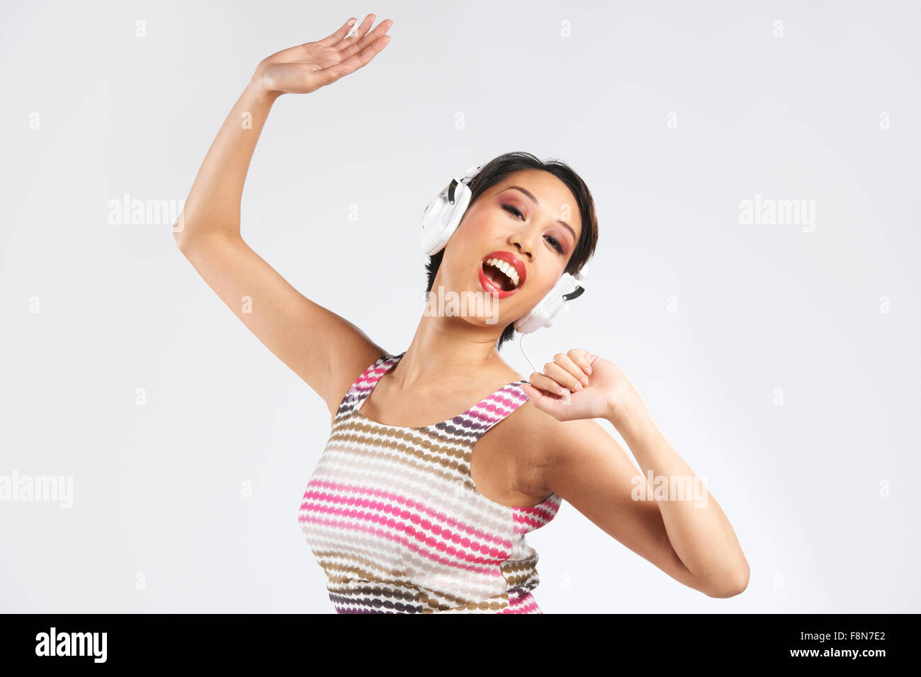 Woman Listening To Music On Headphones And Dancing Stock Photo - Alamy