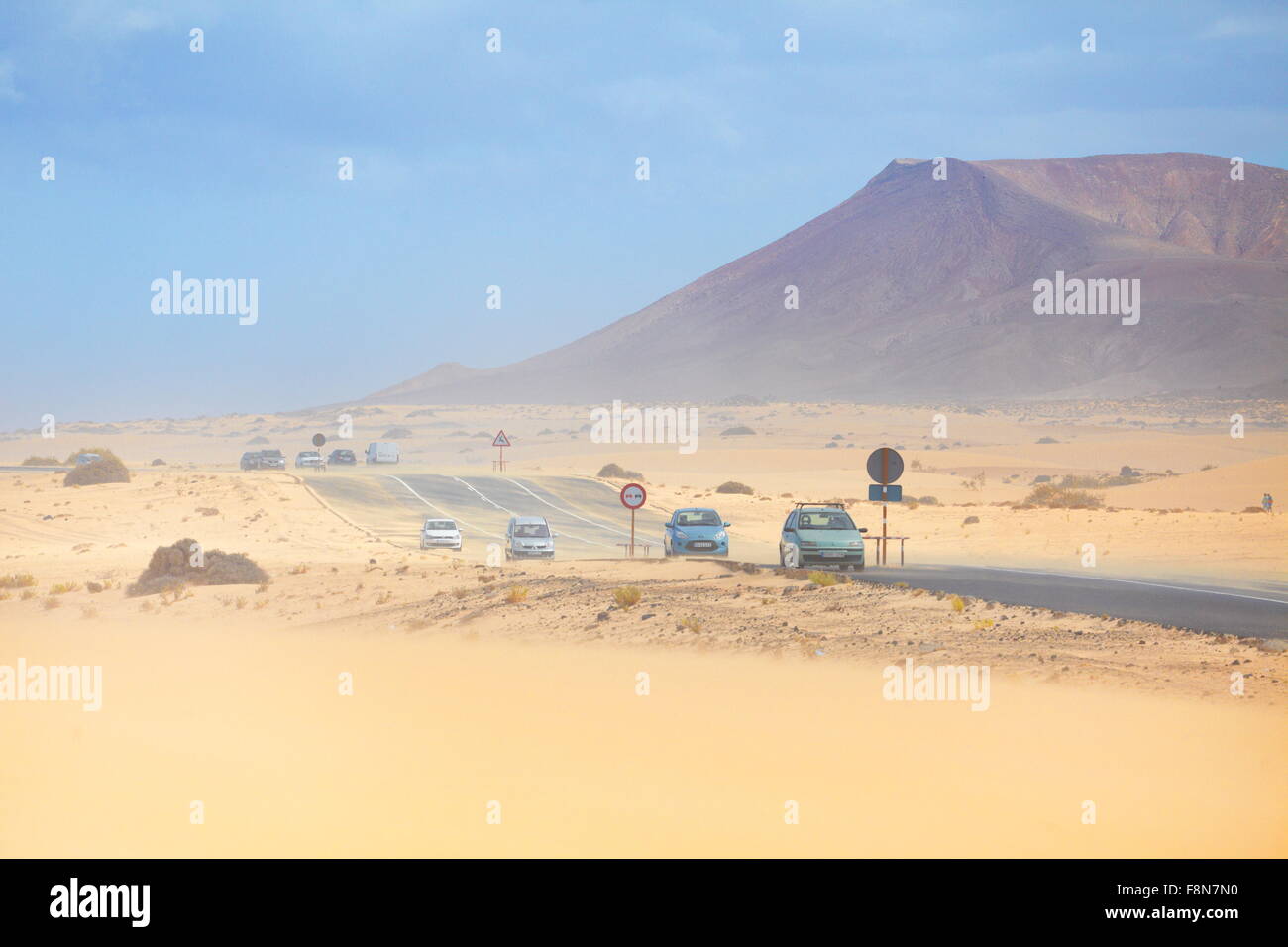 Fuerteventura Island, dust storm in Parque Natural de Corralejo, in the background  volcano Roja, Spain, Canary Islands Stock Photo