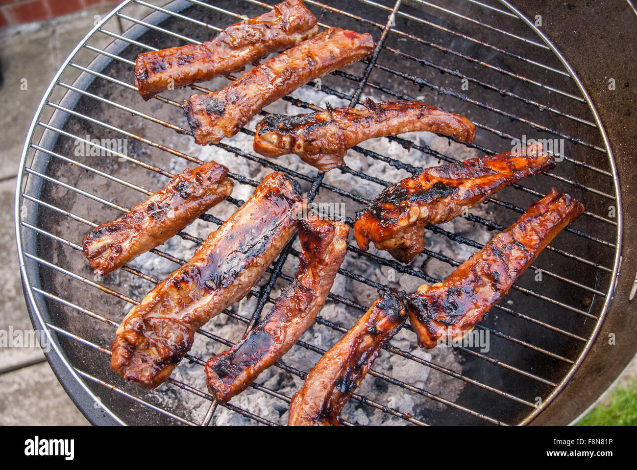 Barbecued pork Ribs on barbecue grill Stock Photo