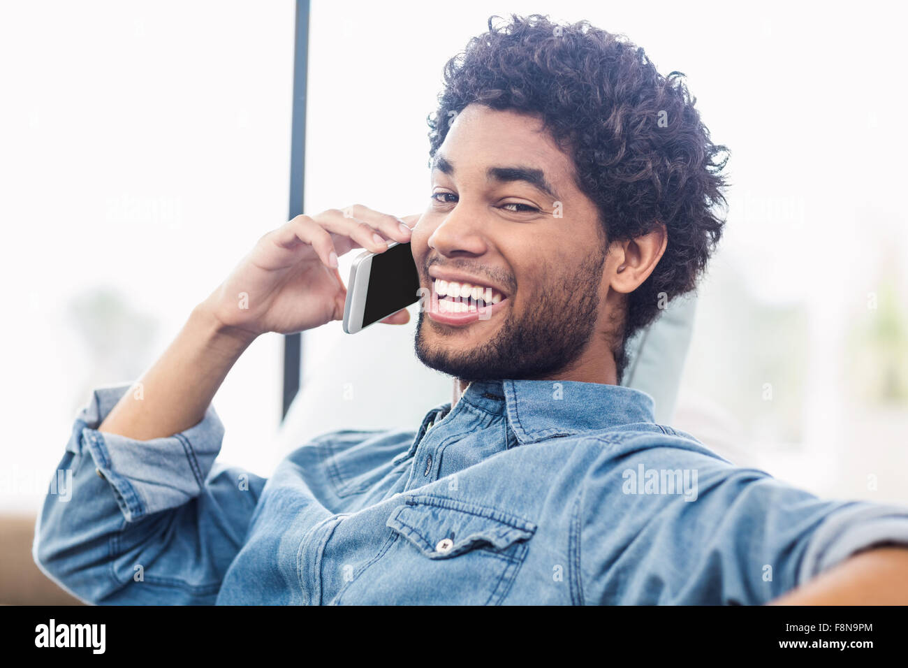 Handsome smiling man on phone call Stock Photo
