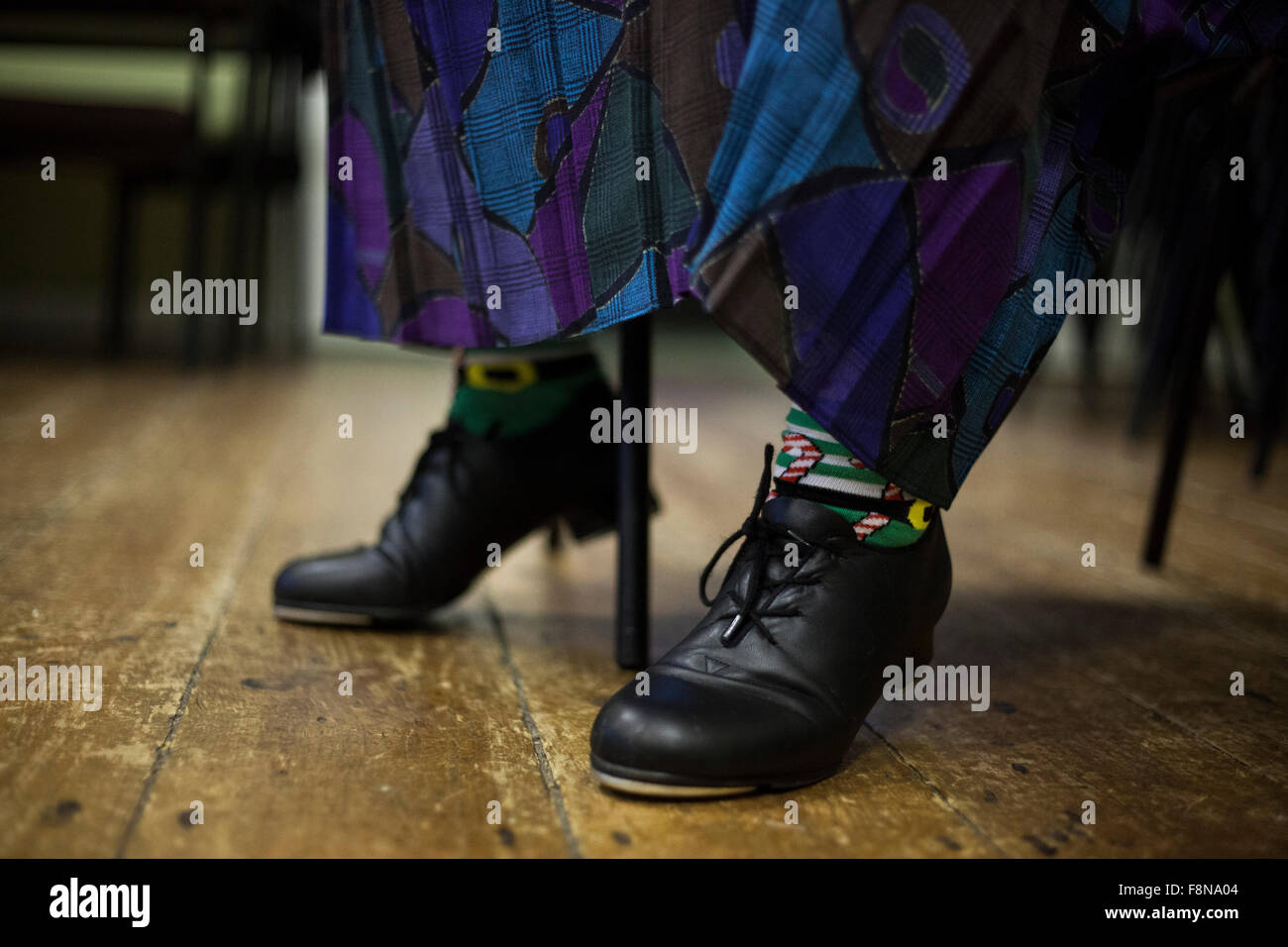 A close up image of a lady in a skirt wearing tap shoes. Stock Photo